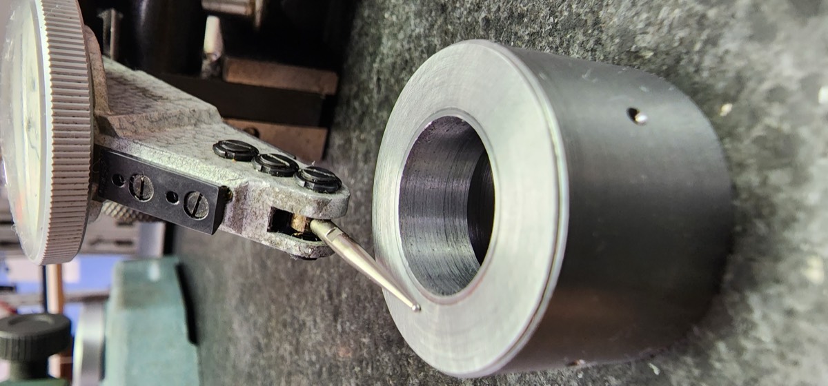 Dial indicator performing in-process inspection on CNC lathe
